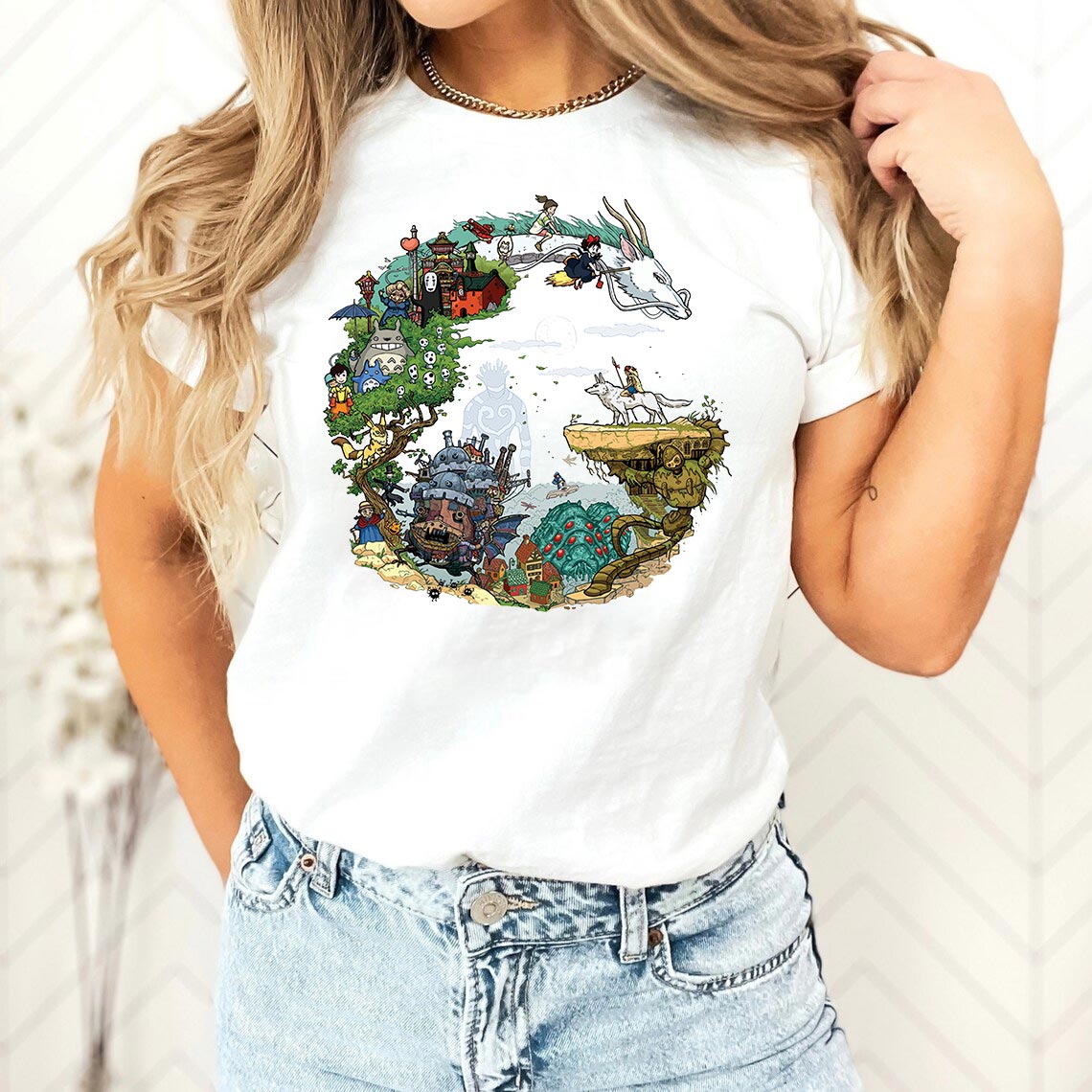 a woman wearing a white t - shirt with a picture of a town on it