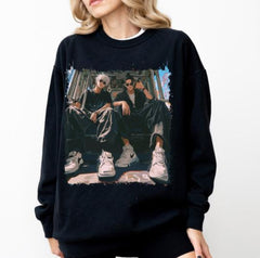 a woman wearing a black sweatshirt with a picture of two people on it