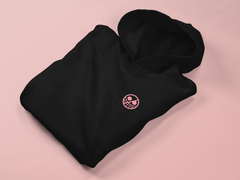 a black hoodie with a pink logo on it